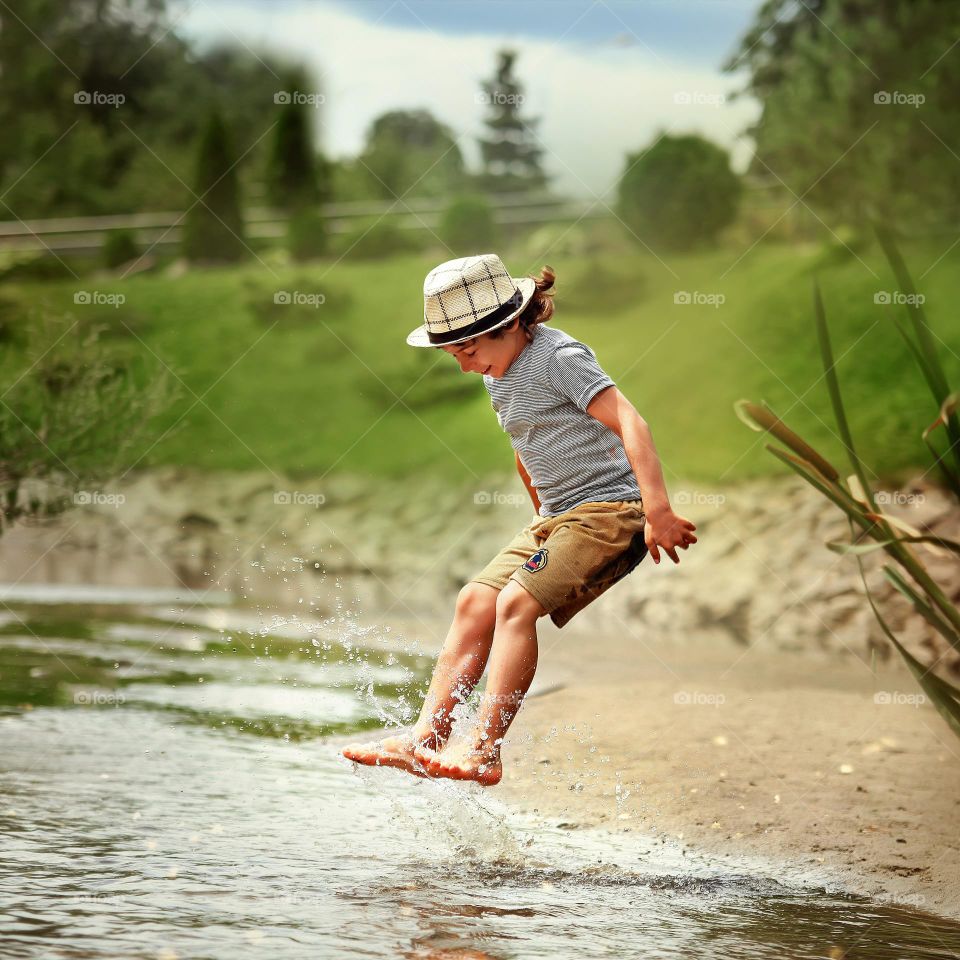 Boy is jumping in the river