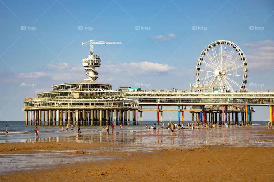 Ferris wheel on a beach during a summer day and clear sky.