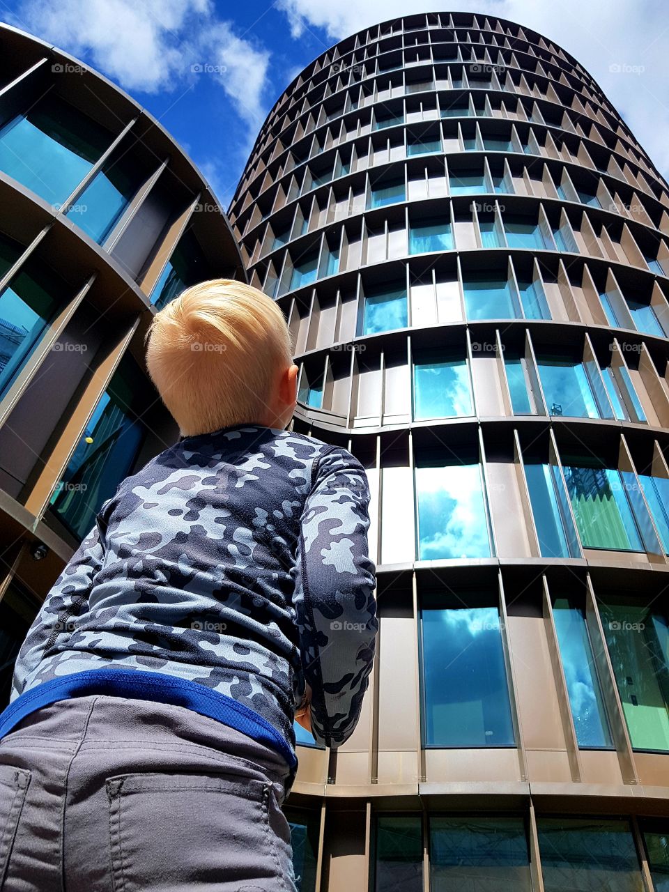 child looking at a skyscraper