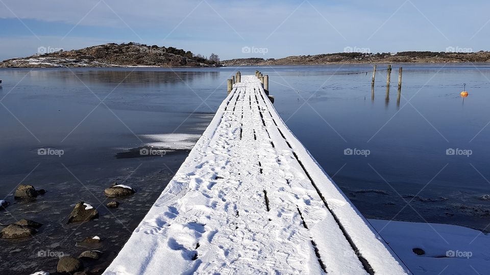 Beautiful sunny winter day on a pier with snow by the ocean, Sweden  - vacker solig dag på brygga med snö vid havet en fin vinterdag , västkusten Sverige 