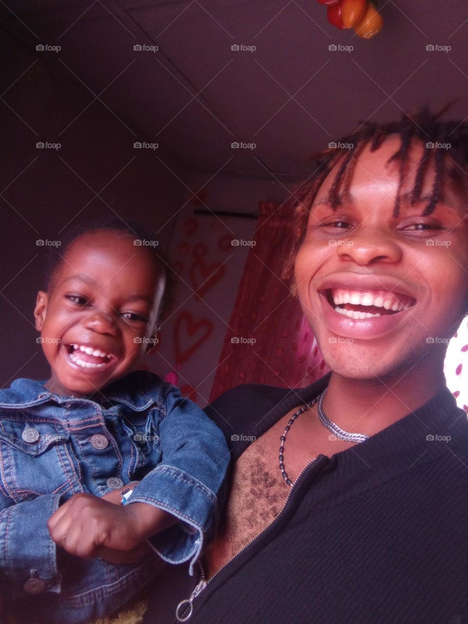 A cute baby happily smiling with an unknown gifter