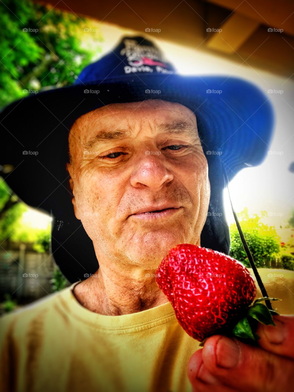Gardener admiring a strawberry