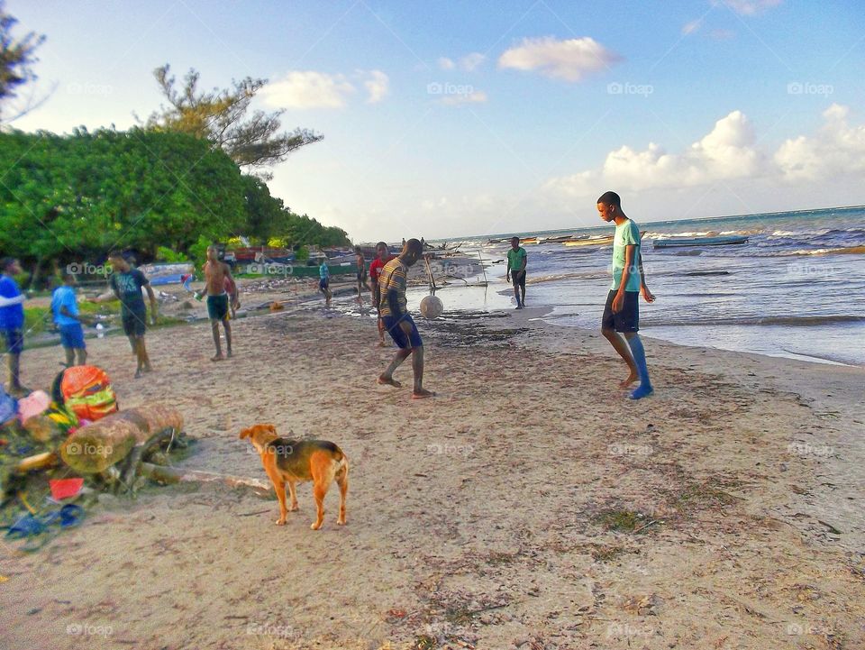 playing football at the beach