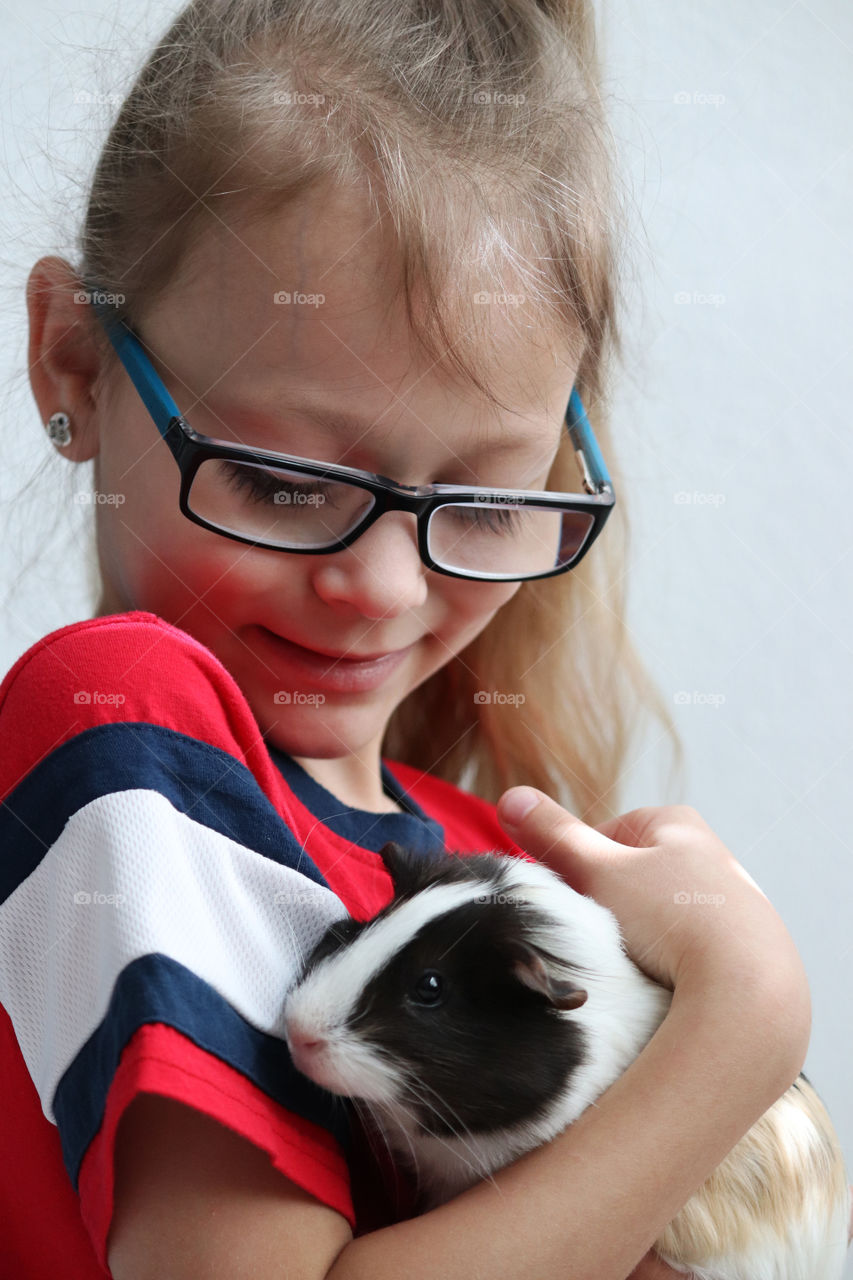 Child holding their guinea pig