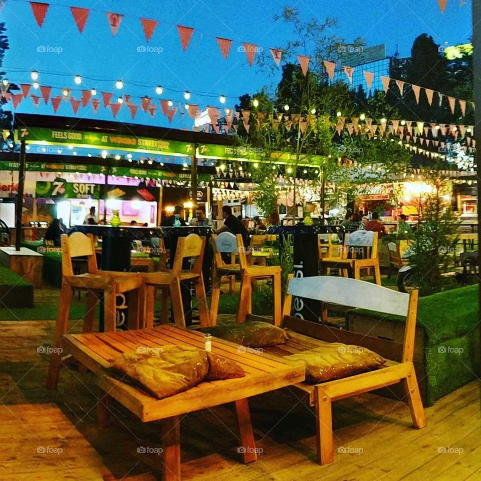 beautiful outdoor street food restaurant with bunting and lights