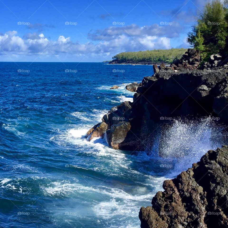 Blue skies and waves at the sea cliffs