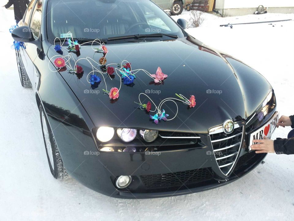 Our beloved Alfa Romeo car dressed in flowers for wedding ride