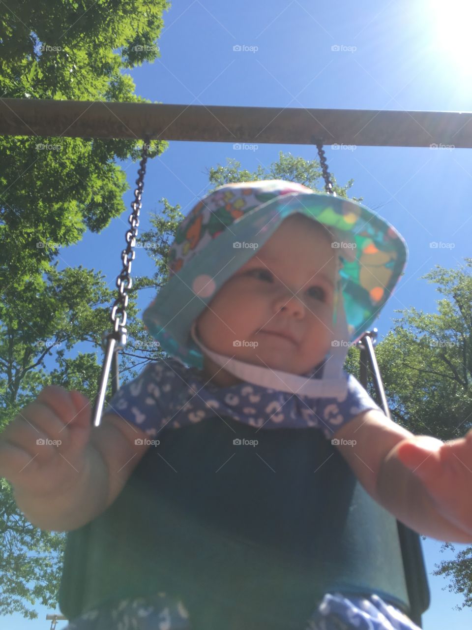 Low angle view of playing on swing