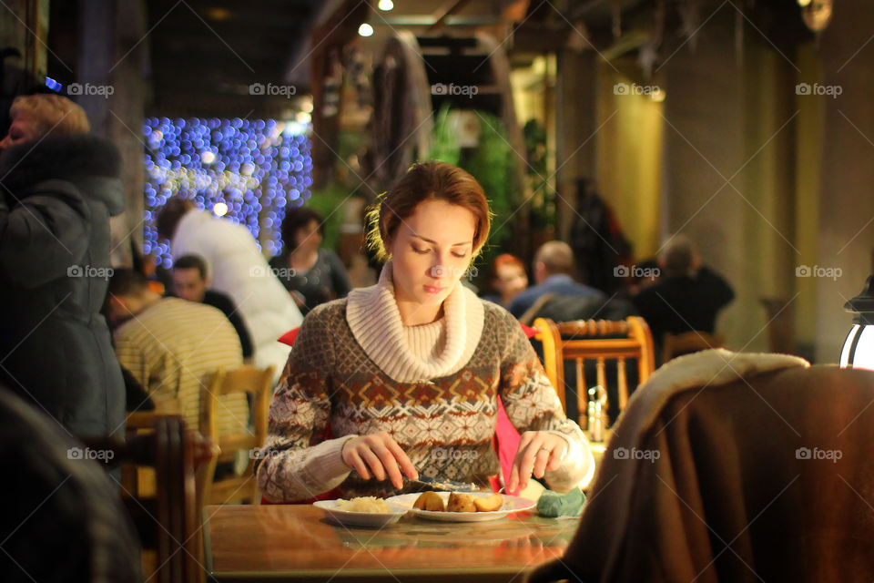 Woman in restaurant with food on table