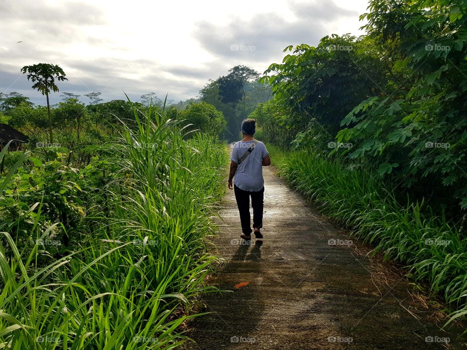 Morning stroll just after the sunrise. Moving towards the light, leaving a  shadow tagging along