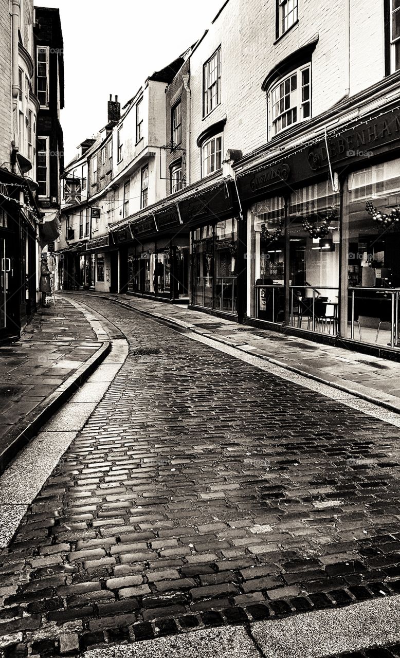Rainy glistening cobblestone streets in the Historic city of Canterbury, England.