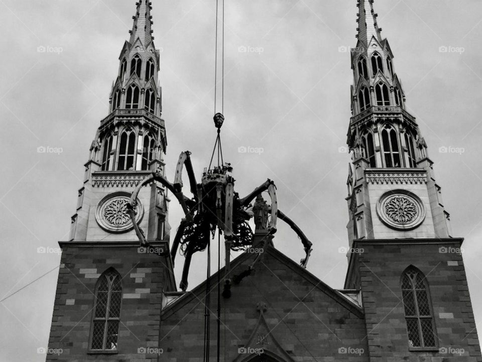 Kumo the giant mechanical spider from the La Machine Company of France being mounted on the Notre Dame Cathedral Basilica in Ottawa, Canada.