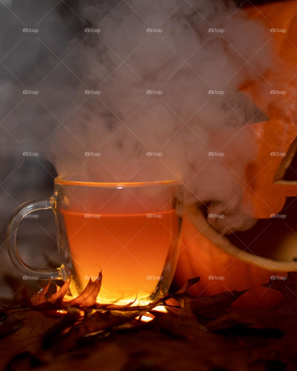 A very steamy glass of cider in a Fall setting