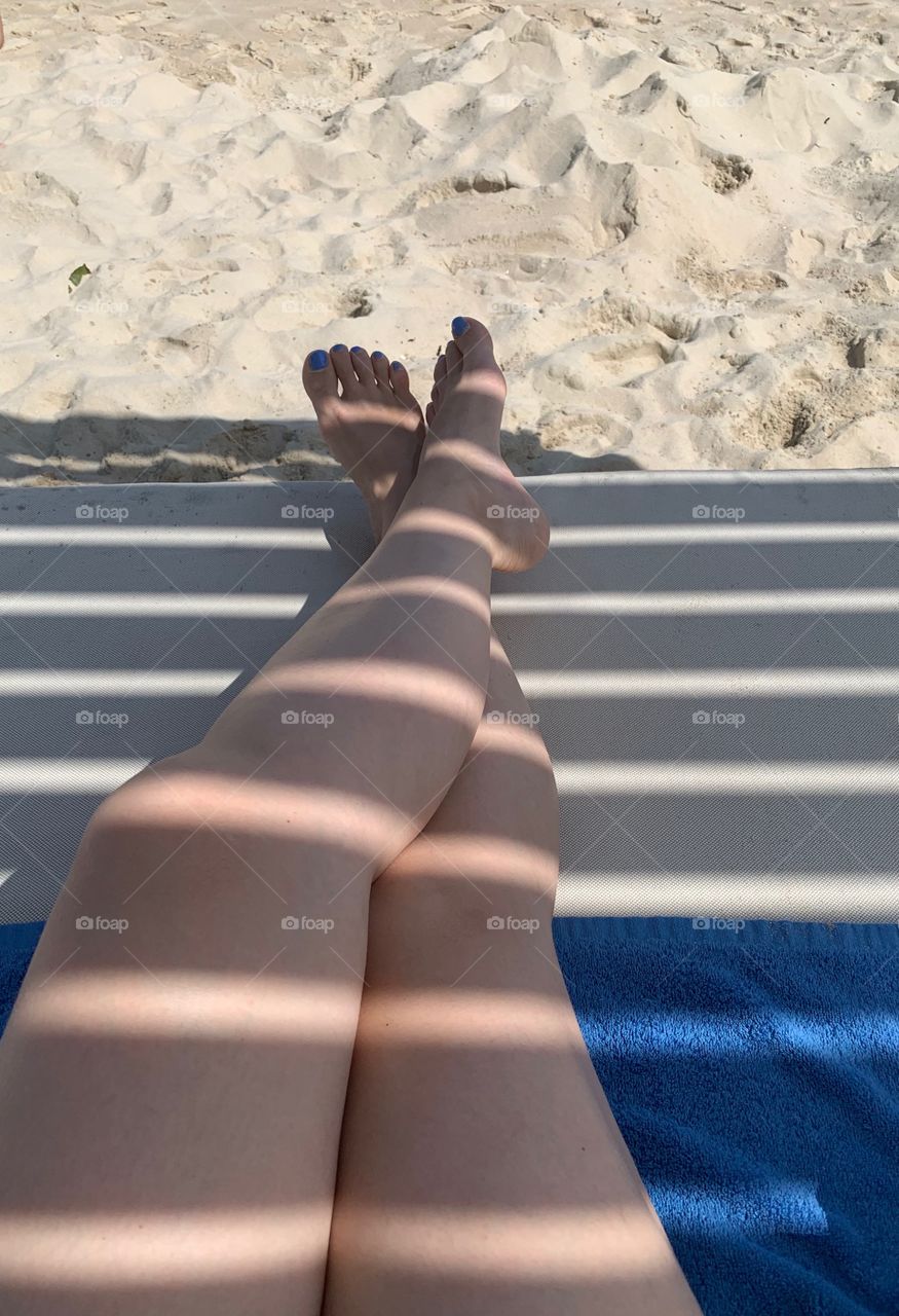 Legs on the sandy beach