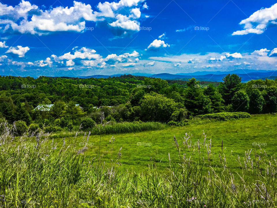 Hills in Vermont with mountains in the distance 