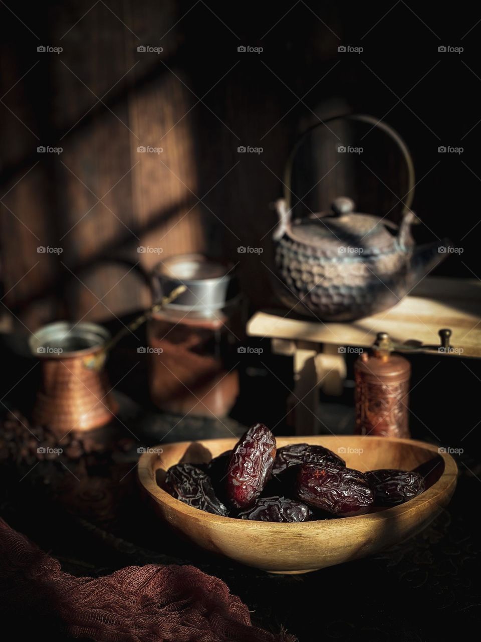 Dates for breaking fast in a wooden bowl and the sun just set down