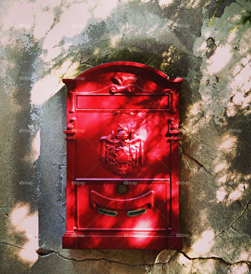 red mailbox in shadows