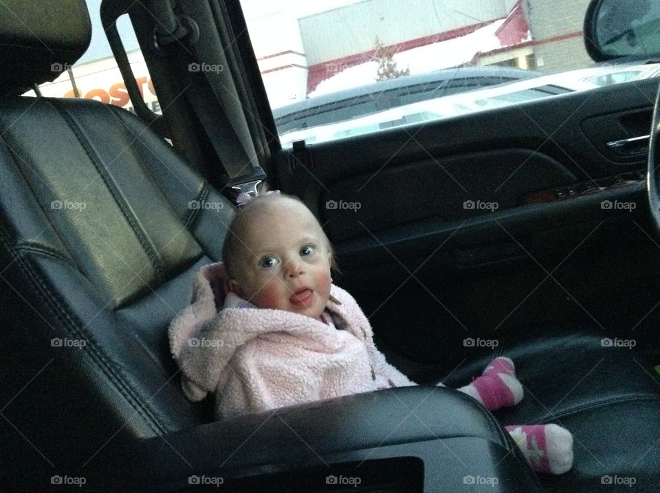 Baby with Down syndrome sitting in car