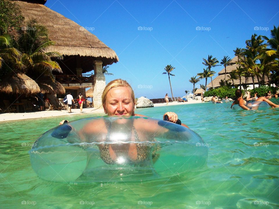 Woman in swimming pool with inflatable
