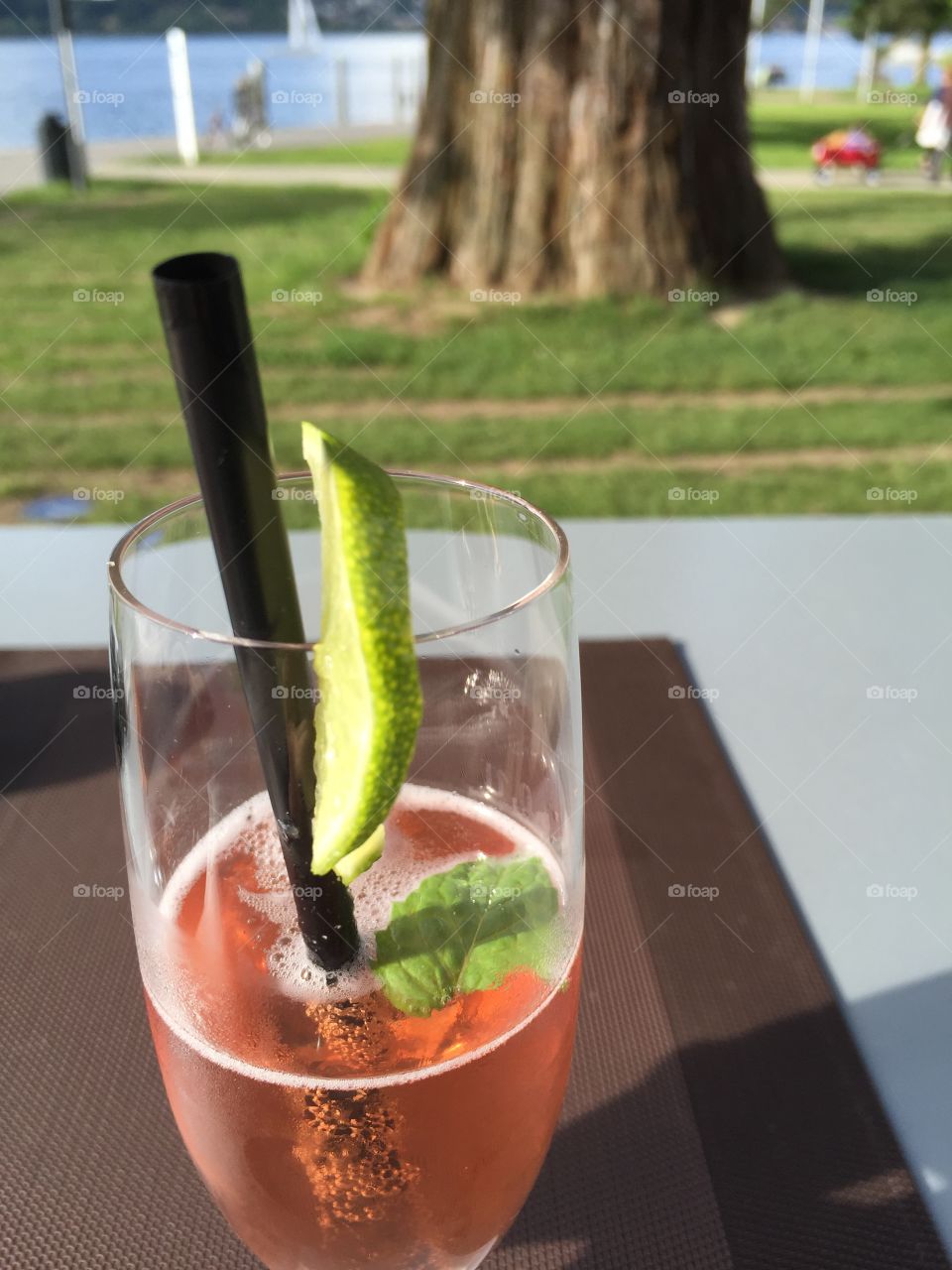 Enjoying a sparkling summer drink with lake view on a warm evening