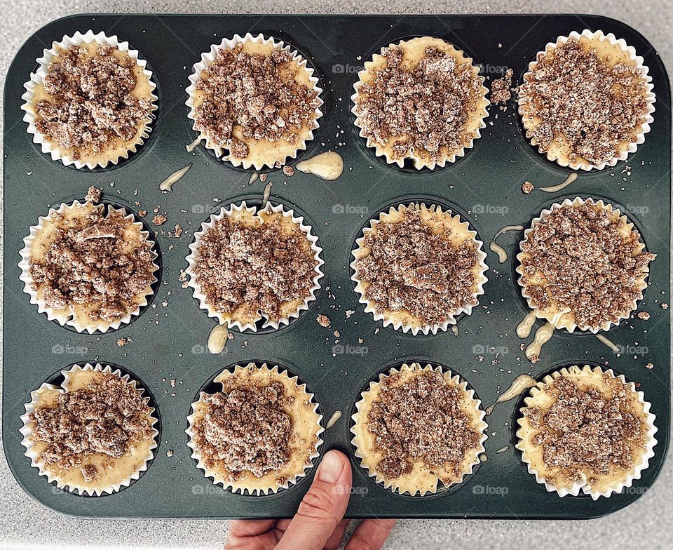 Woman making Cinnabon Strudel Muffins, woman prepares muffins in a pan, muffins ready to go into the oven, woman prepared a treat, mommy makes a treat for her child, messy muffins, messes in the kitchen, making homemade desserts, Cinnamon Muffins 