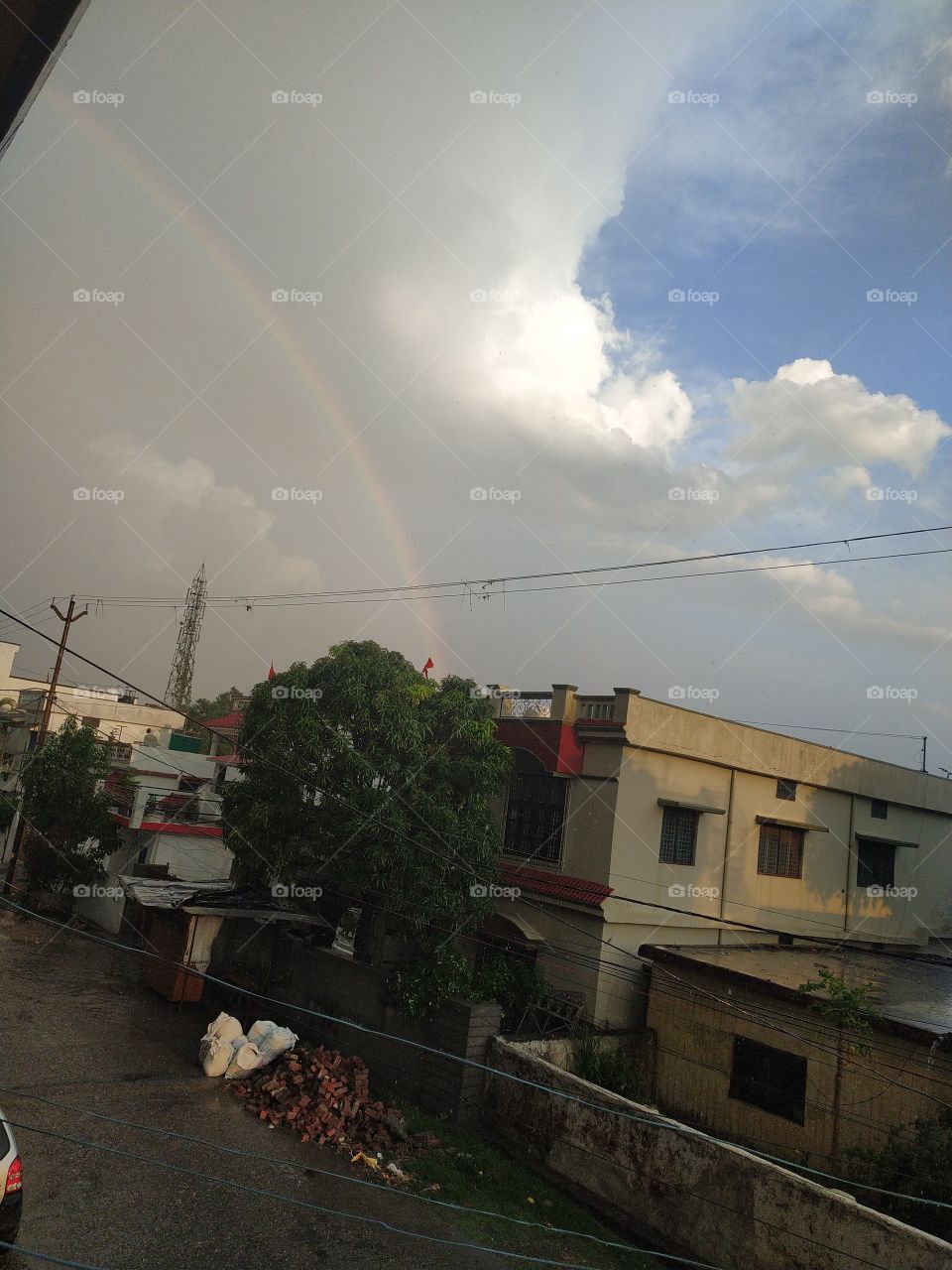 Rainbow forming amid the movement of thundering clouds