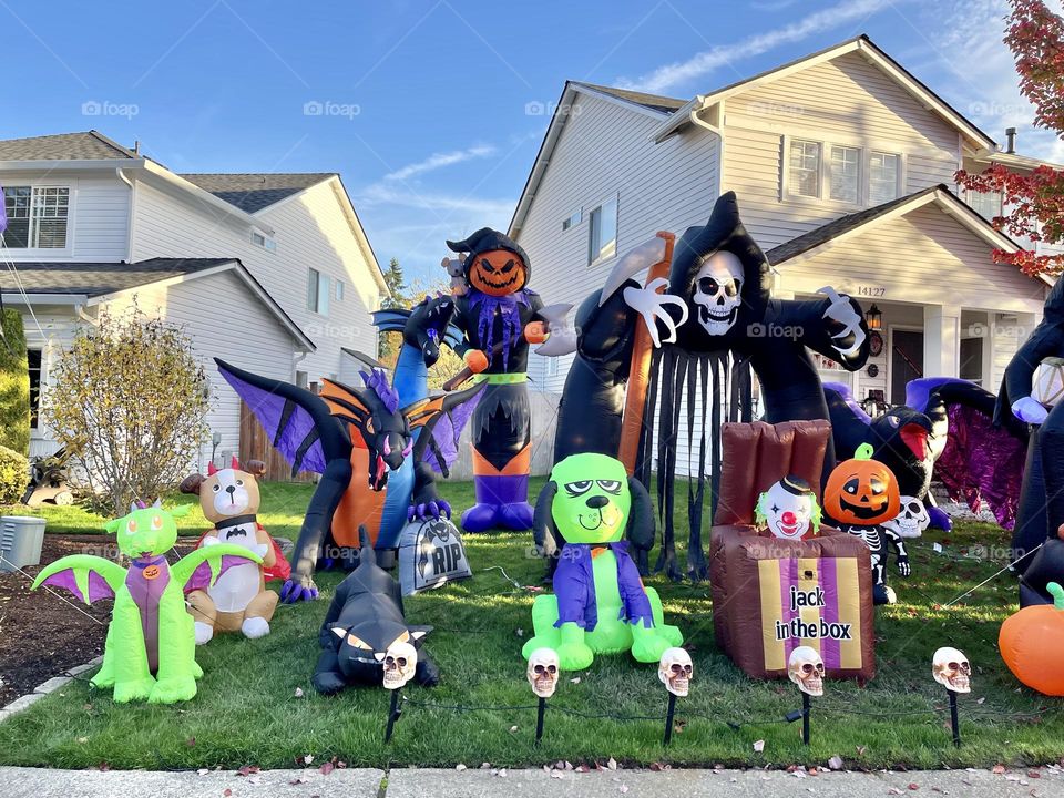 Many monsters figures near the house. Halloween decorations 