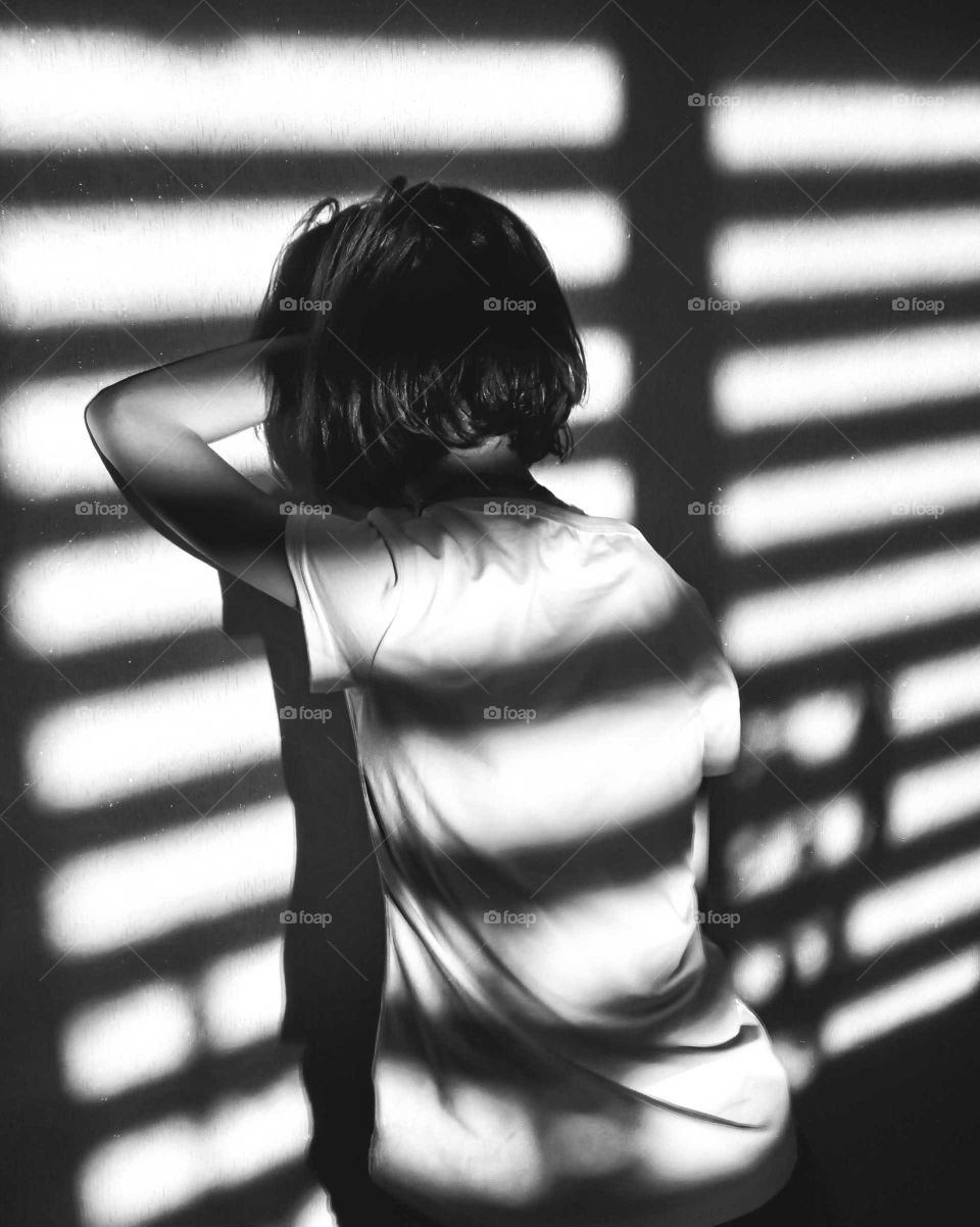 black and white photo of a girl in the sun