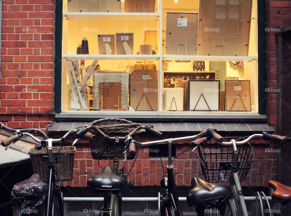 Bicycles line store window in city nook