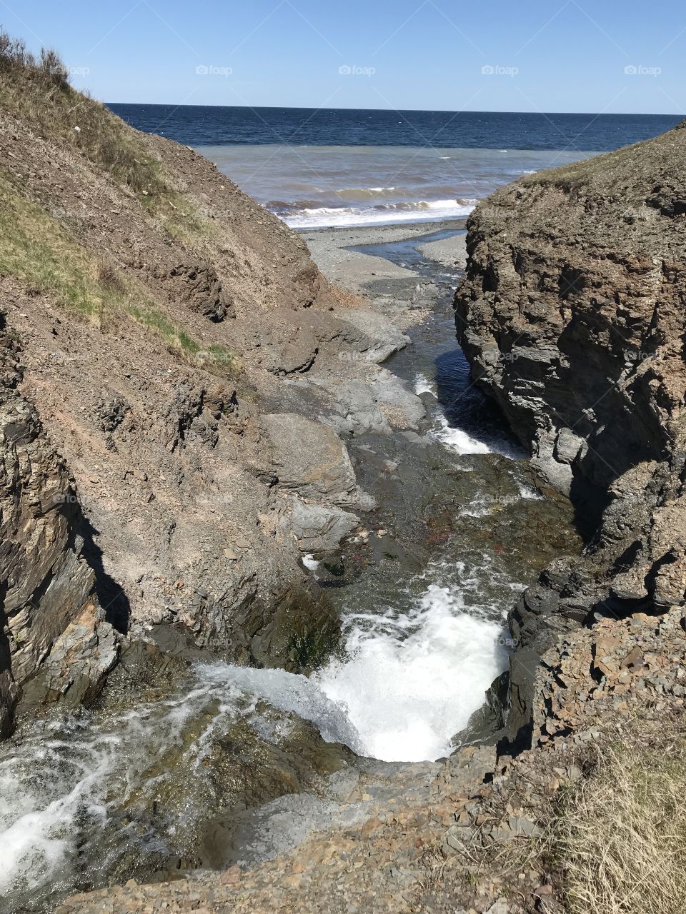 A waterfall that merges with the ocean. Nova Scotia, Canada.