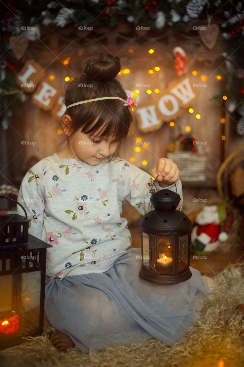 Little sisters near fireplace at Christmas Eve 