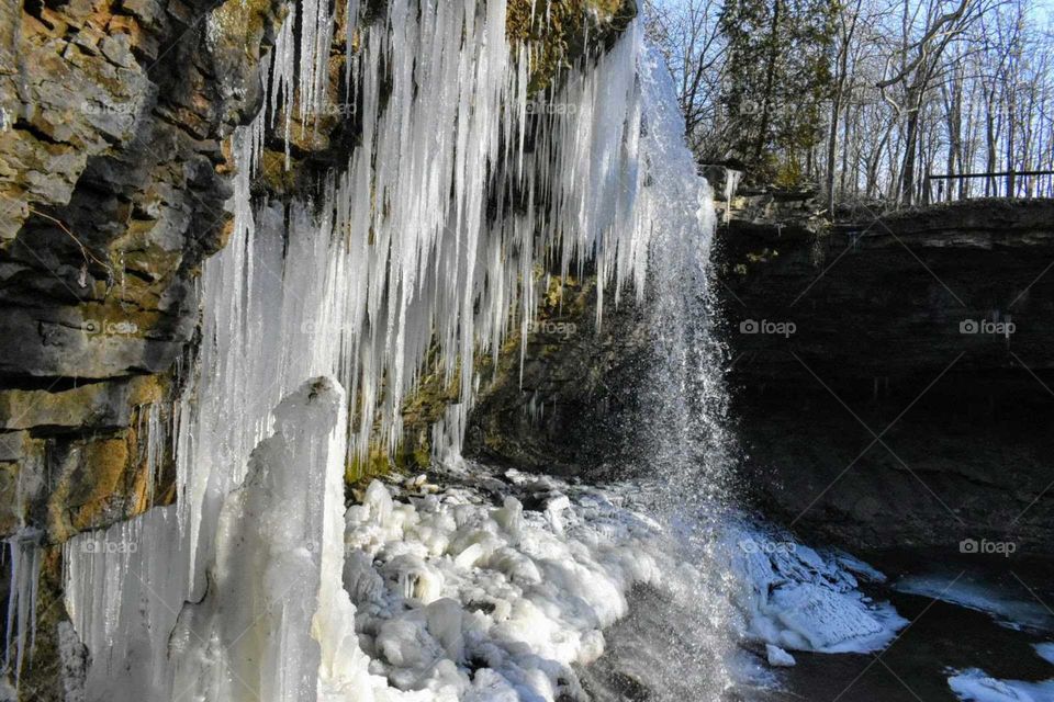 waterfall freezing around caves