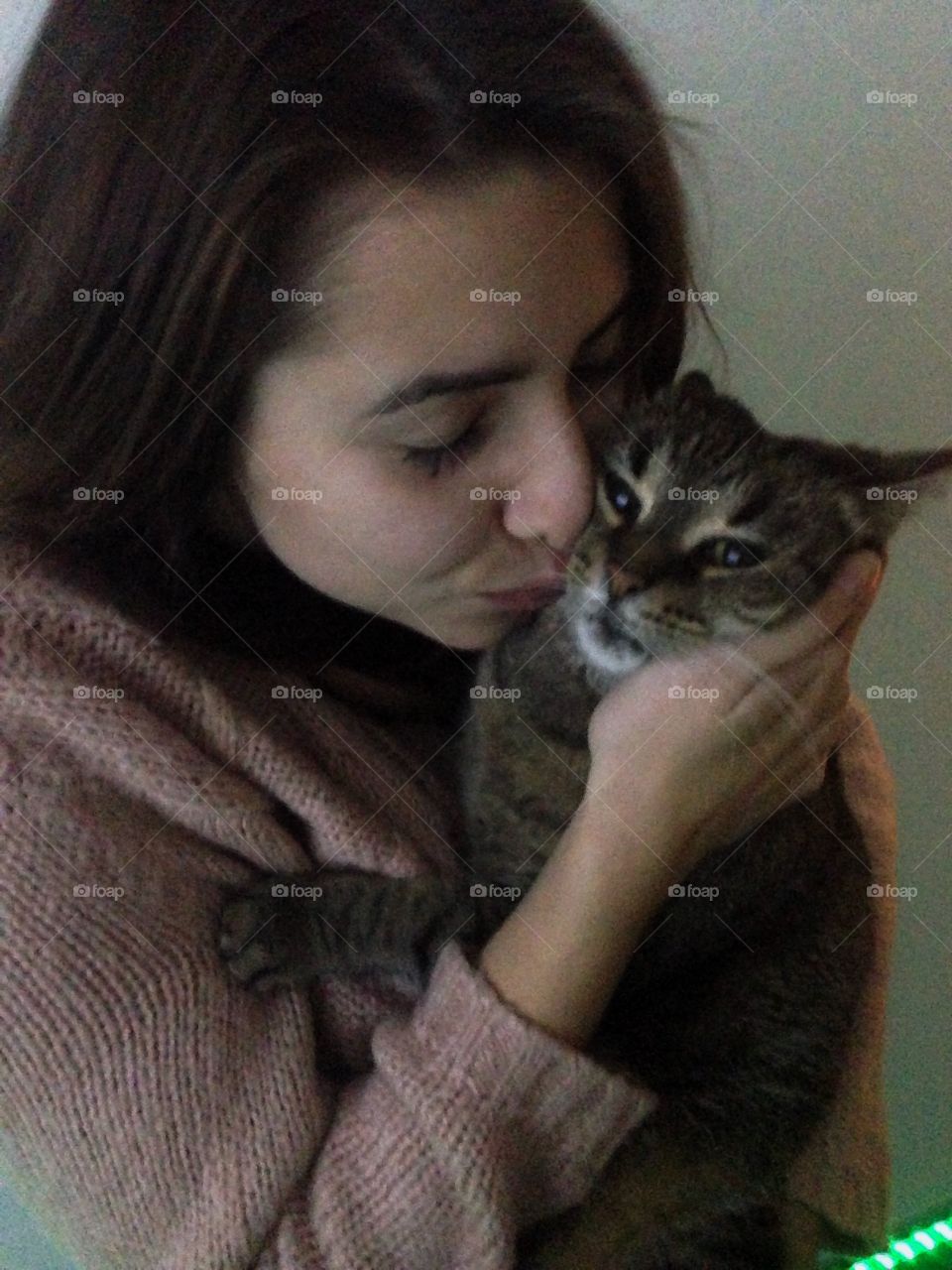 Beautiful woman kissing a cat