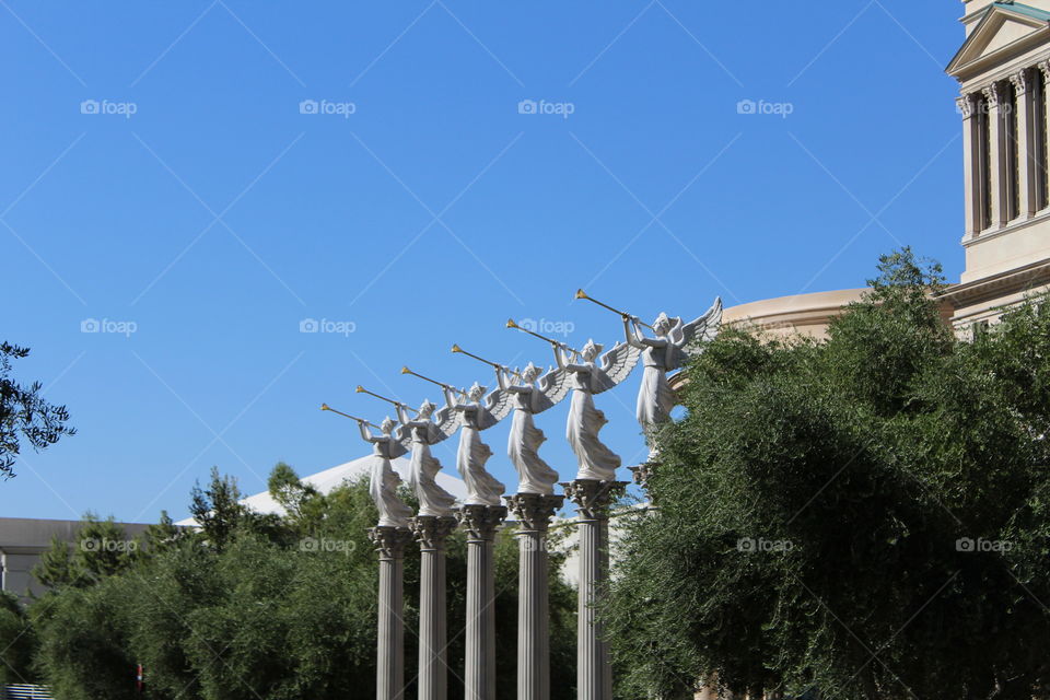 statues blowing trumpets