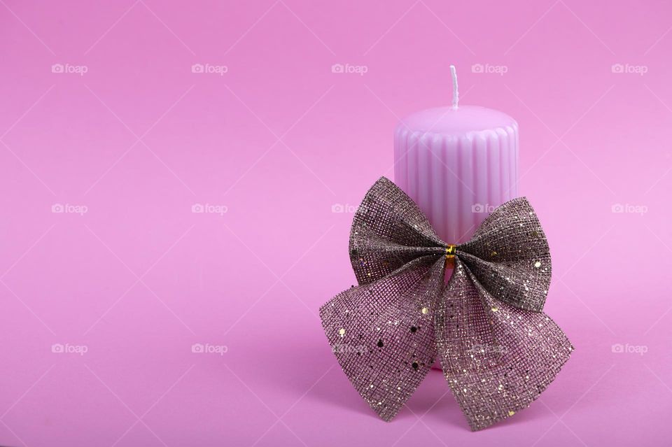 Pink candle on pink background