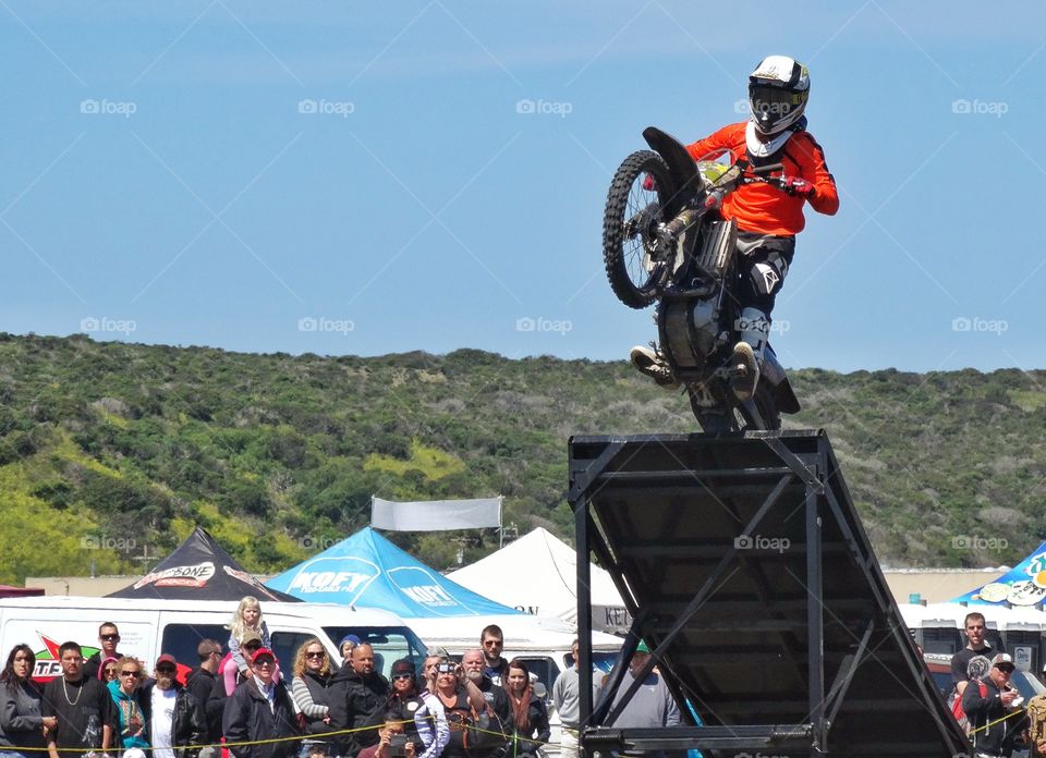 Motorcycle Stunt. Motorcycle Rider Jumping Off A Ramp
