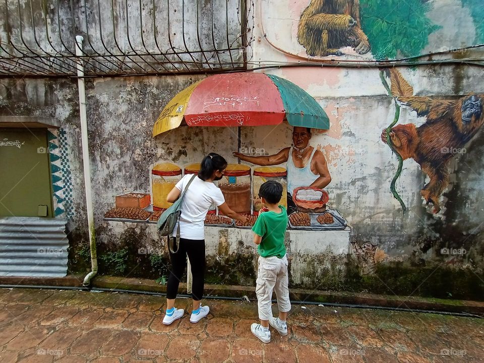 Mother and son are admiring the mural