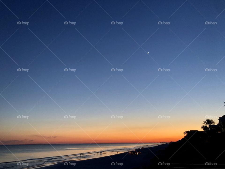 Festivities beginning at sunset and moonrise on the Gulf of Mexico 
