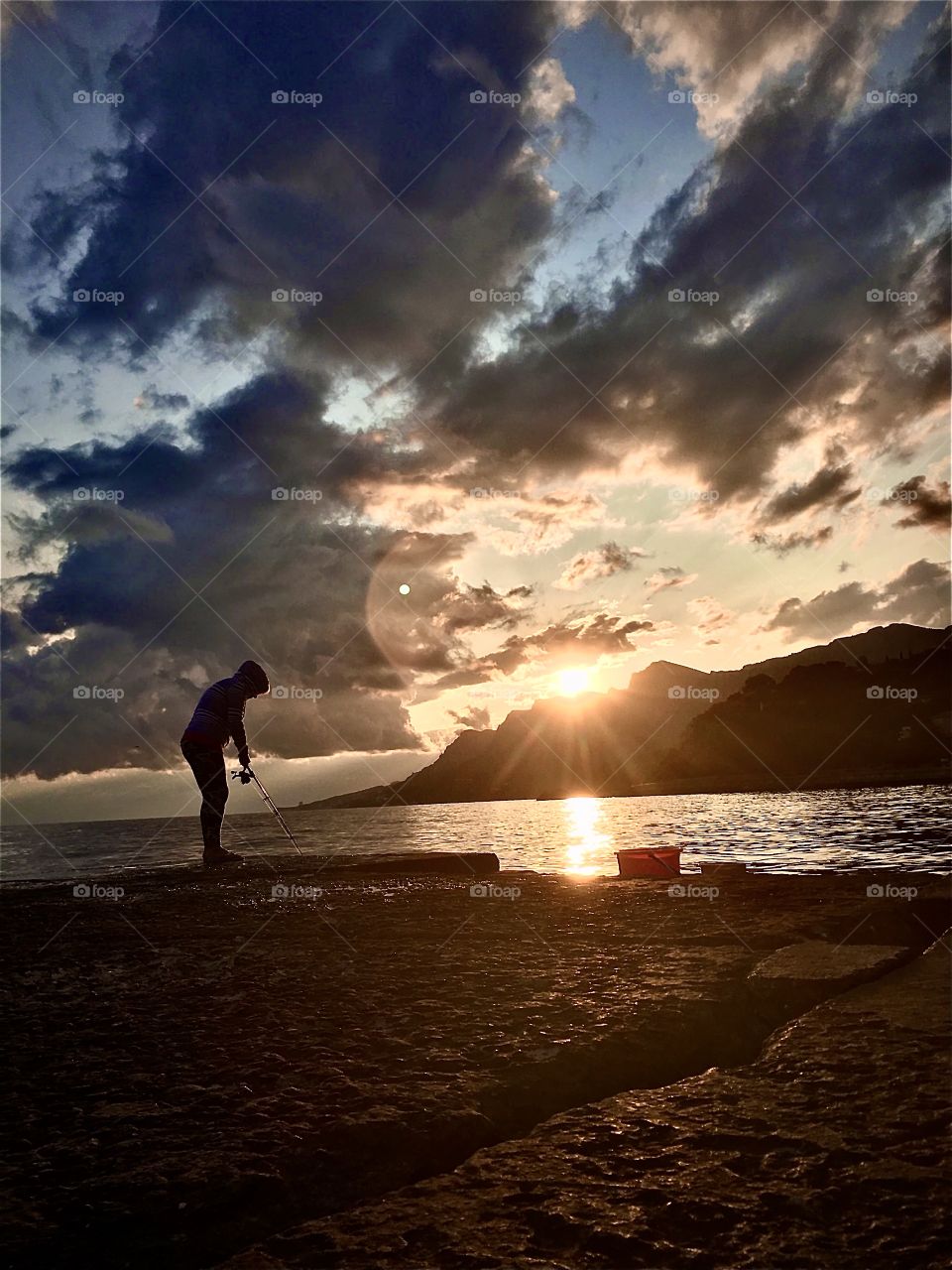 Fisherman in sunset. 