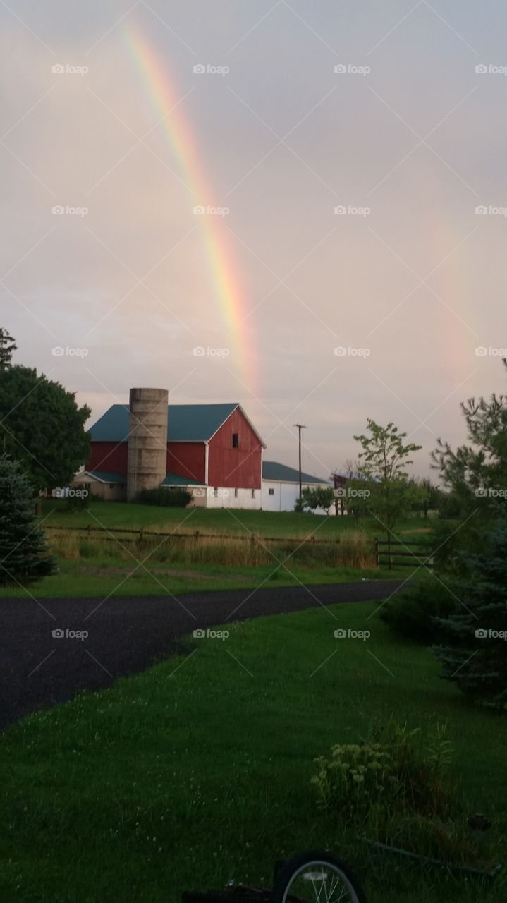 Rainbow over barn.. Just a beautiful day.