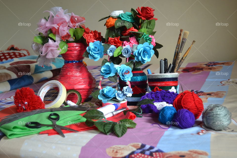 Flowers by papers & non woven bags, flower vase by newspaper paper, a handmade doll, and pencase