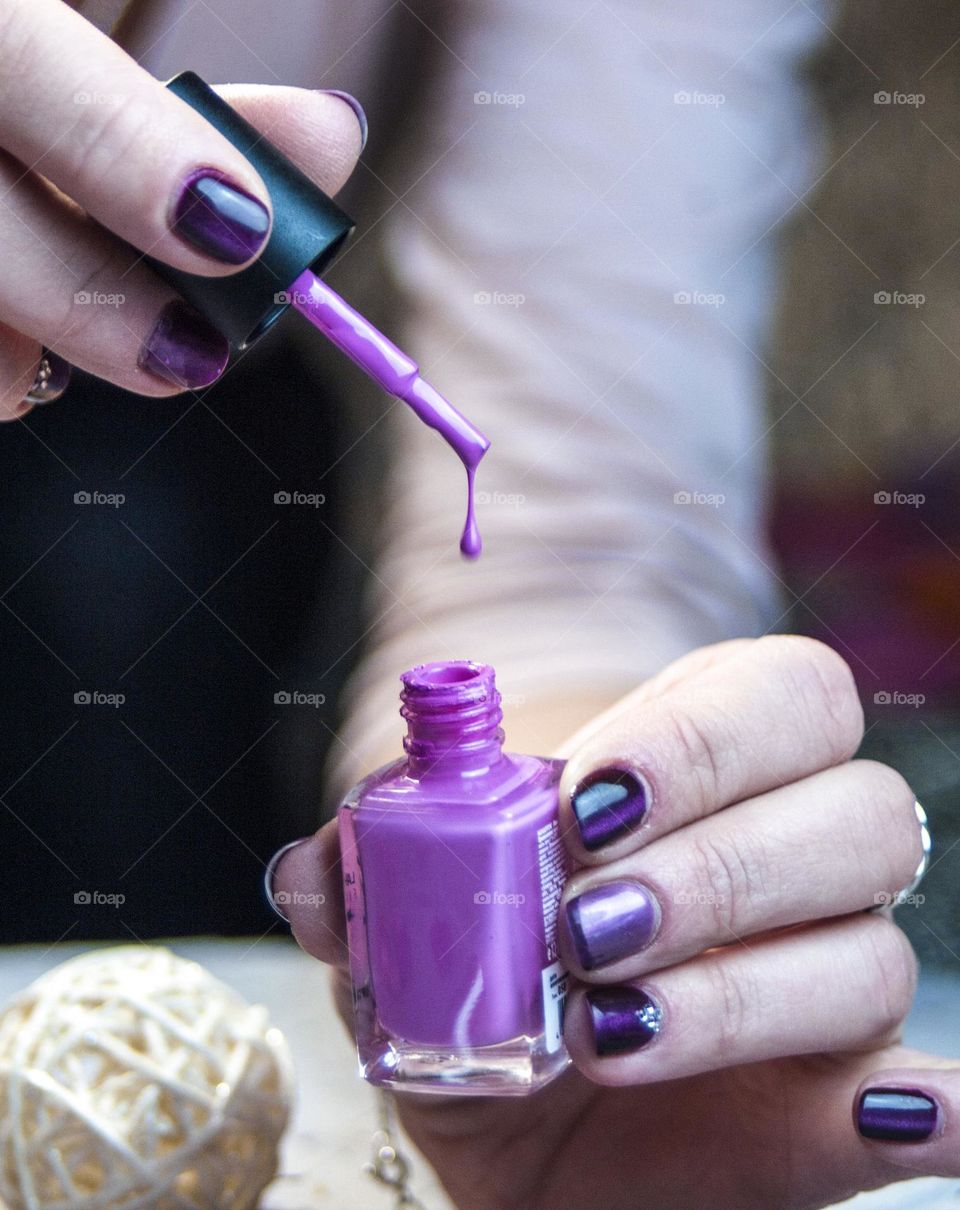 girl paints her nails