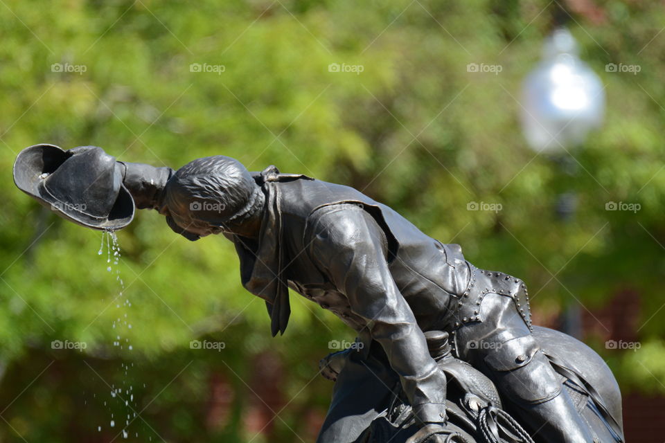 Cowboy statue drinking