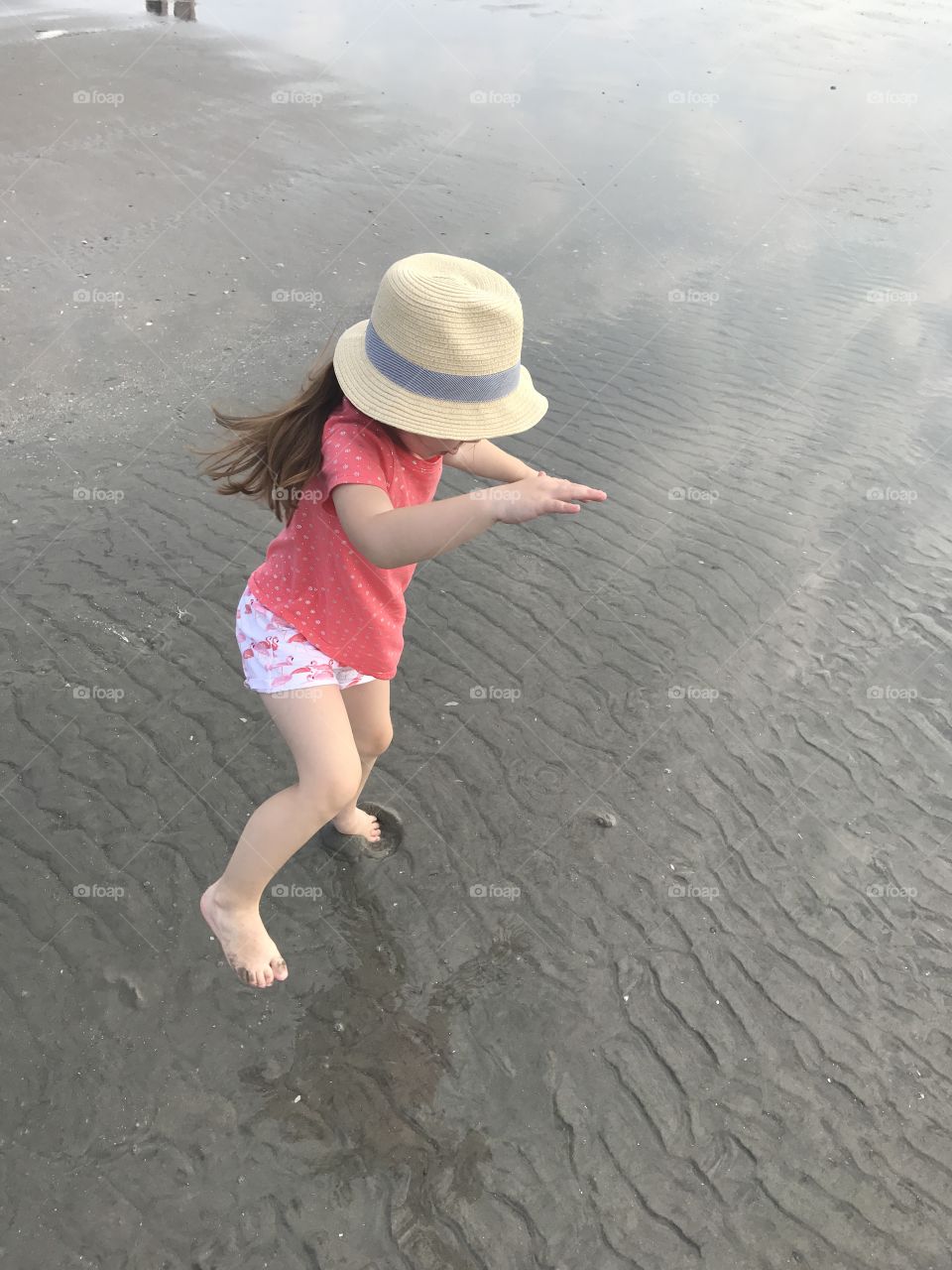 Little girl dancing on the beach