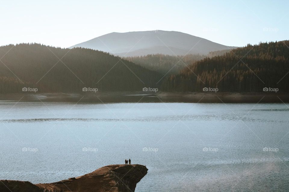 people admiring the lake in a minimal scenery