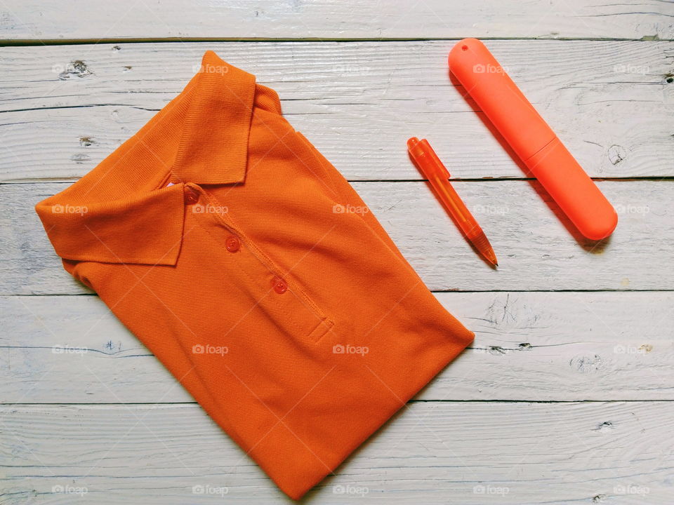 Orange fashionable t-shirt, pen and case