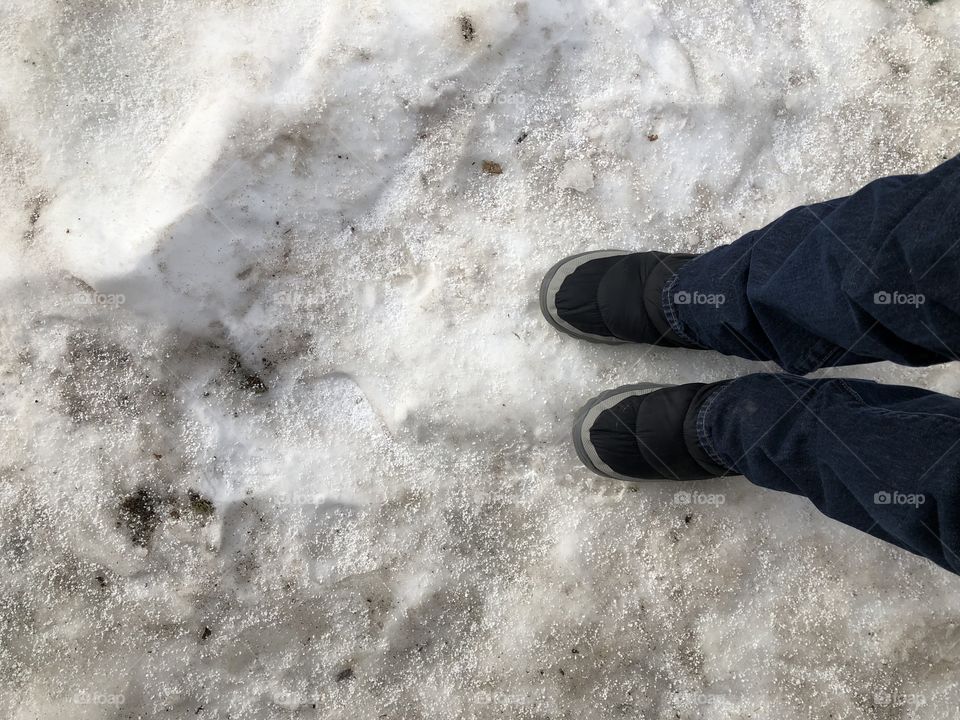 Snow boots in the icy snow