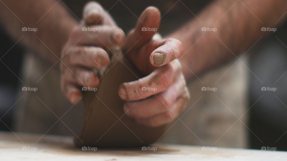 Potter's hand making pottery