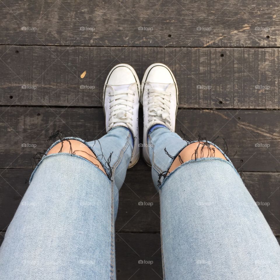 Fashion hipster cool woman with white sneakers, soft vintage toned colors great for any use.