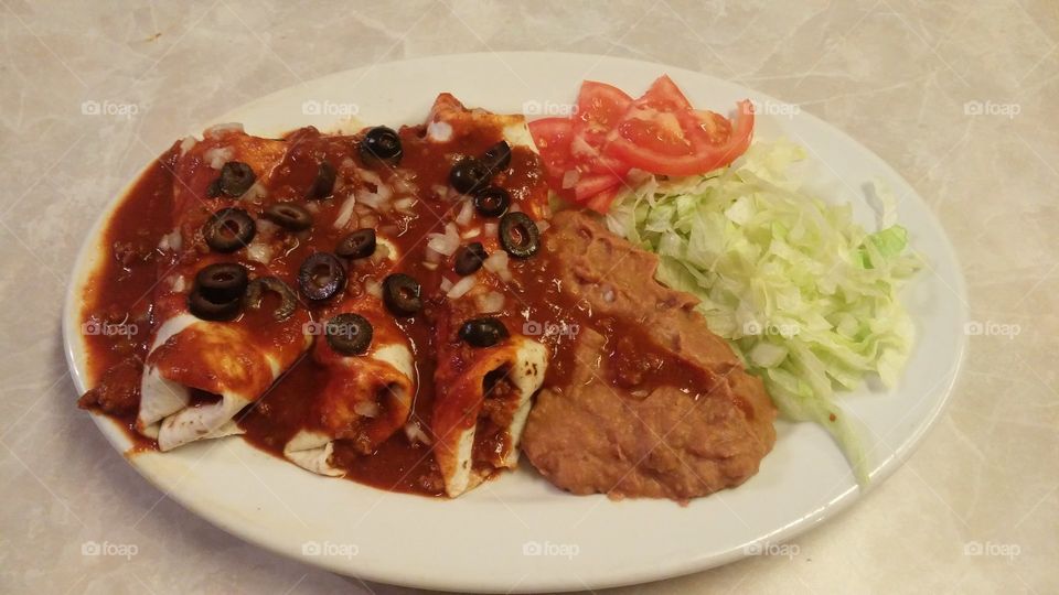 Plate of homemade enchiladas, looks like restaurant. Mexican food. Authentic white-girl enchiladas.